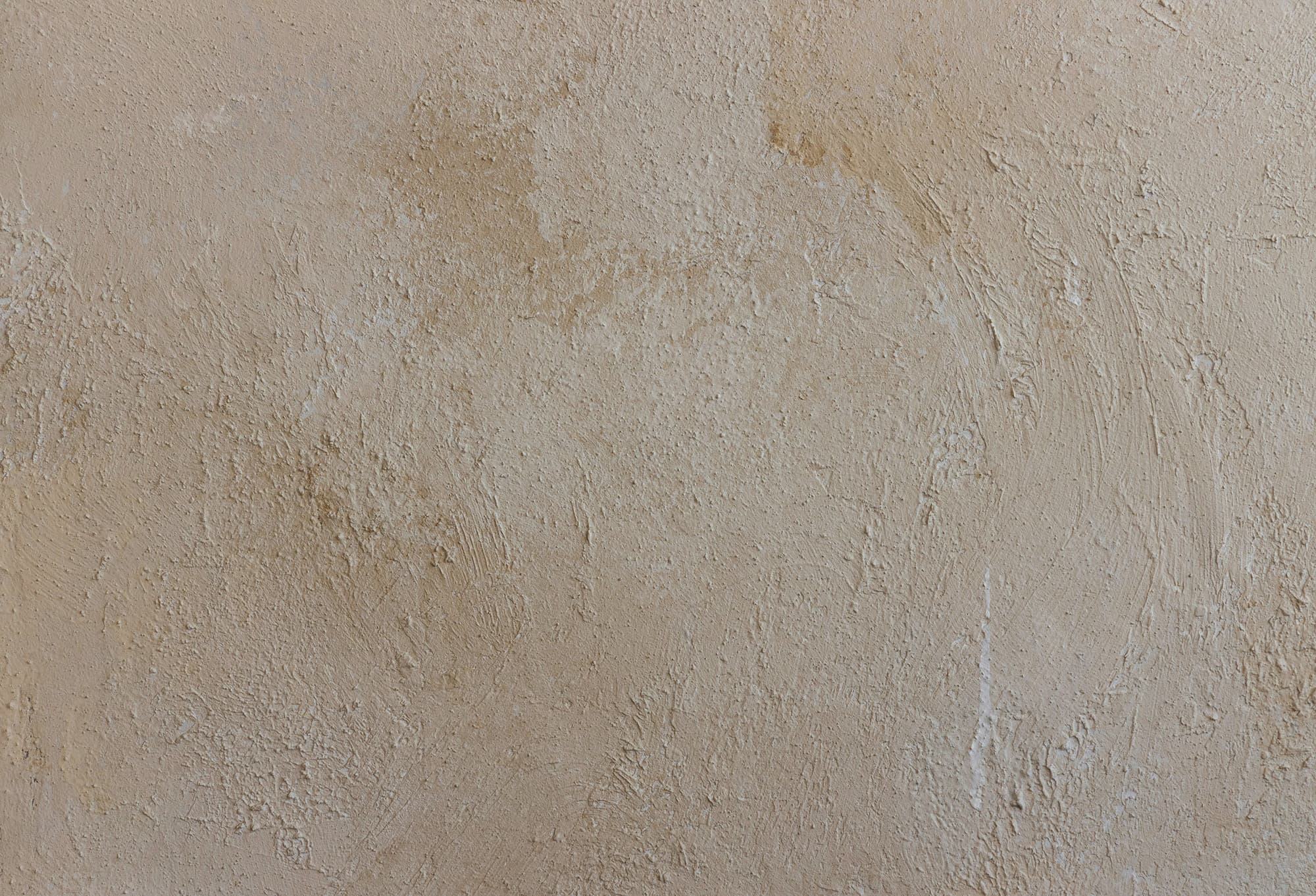 An abstract golden textured pattern resembling brushstrokes on canvas. 