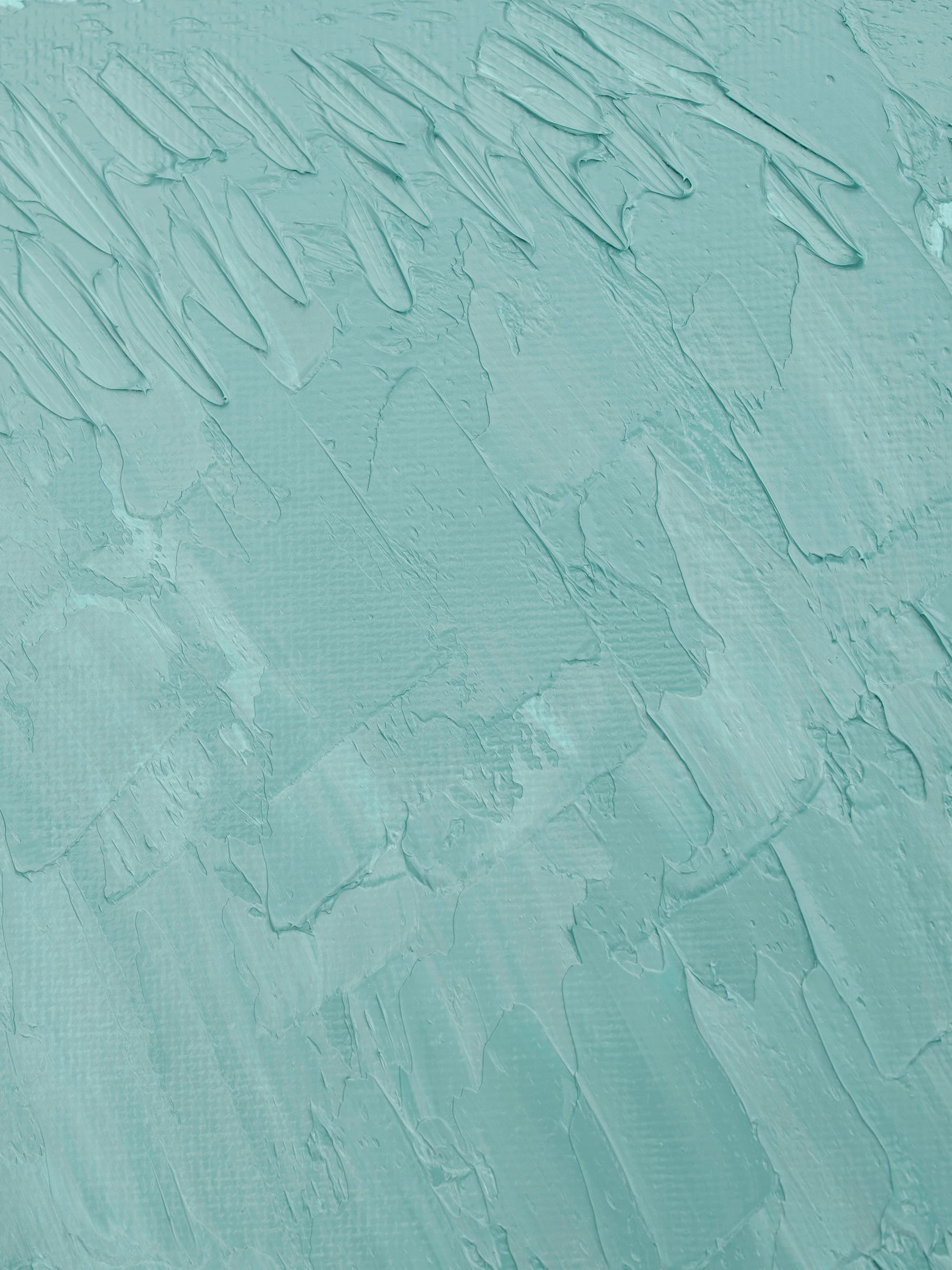 Abstract light teal textured brushstrokes resembling a painted canvas.
