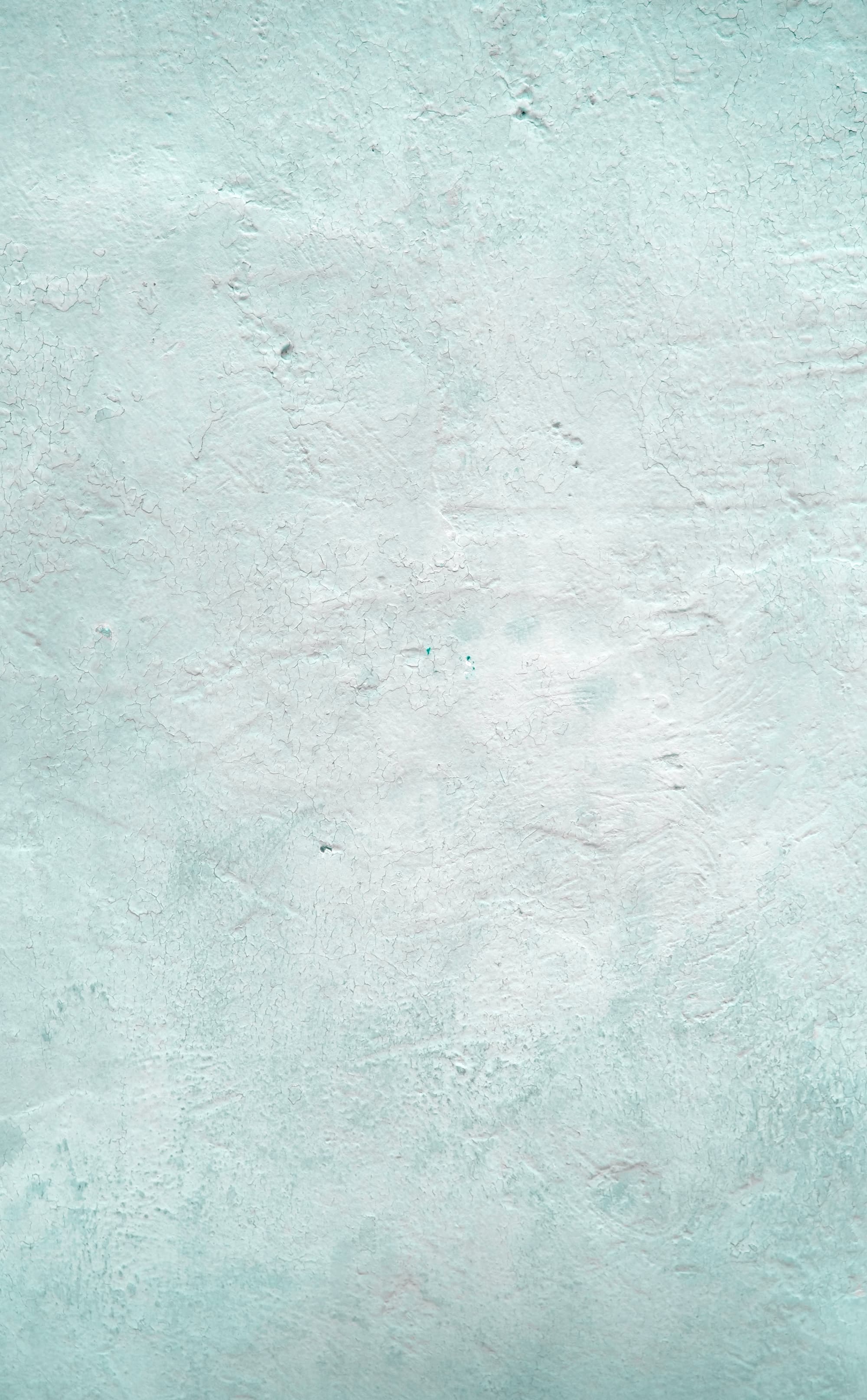 A light blue wall with a stone-like texture.