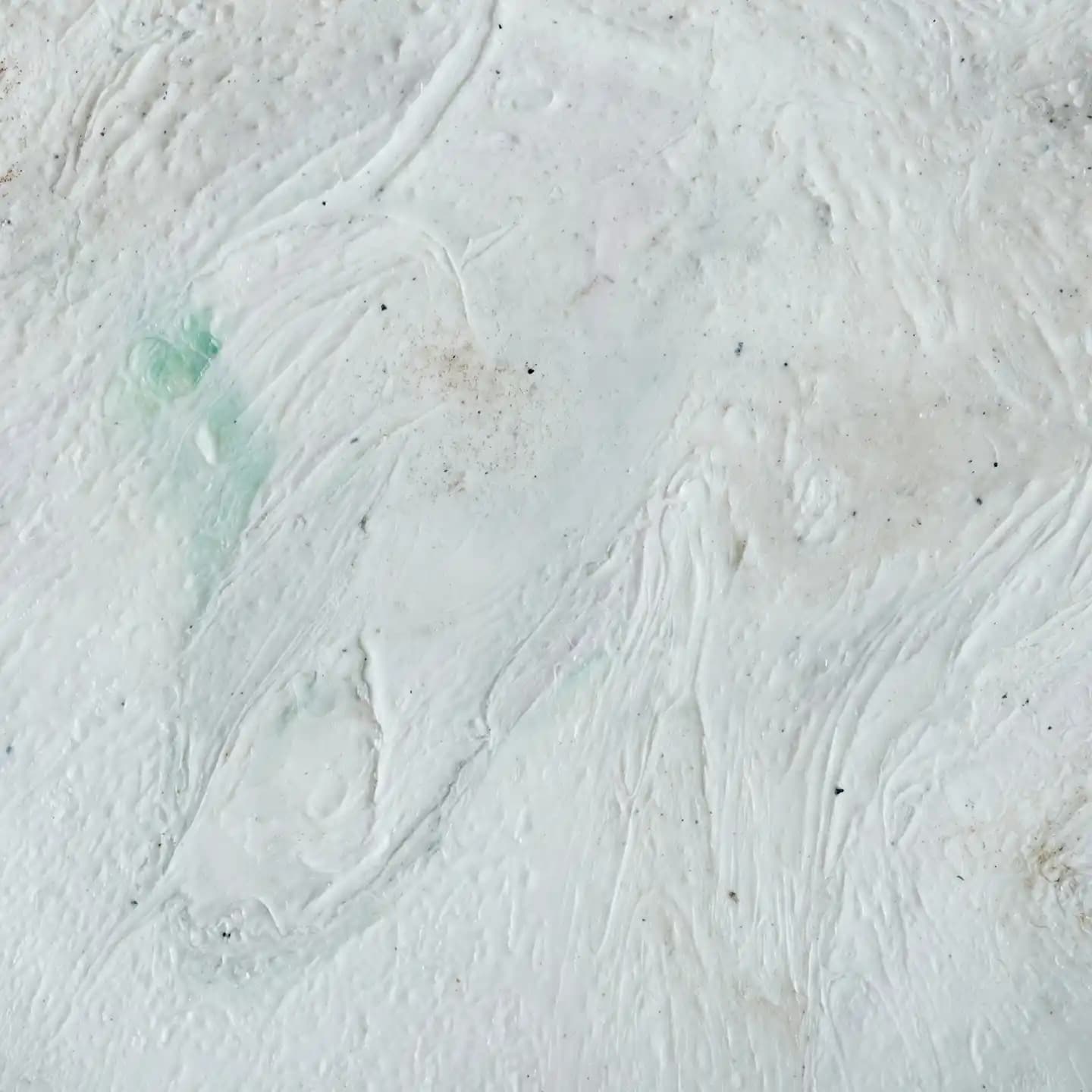 Abstract white textured brushstrokes resembling a painted canvas.

